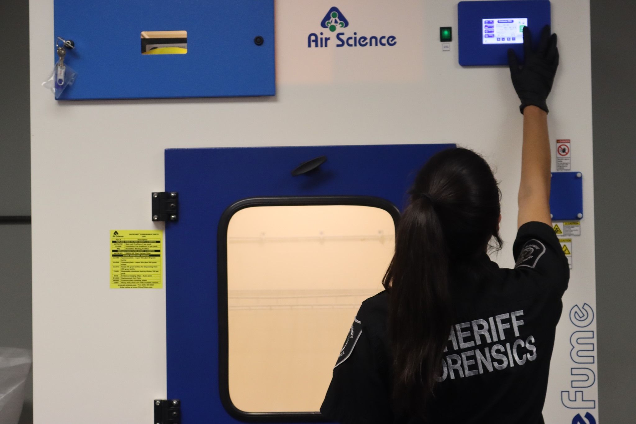 Forensics lab workspace with various equipment and tools