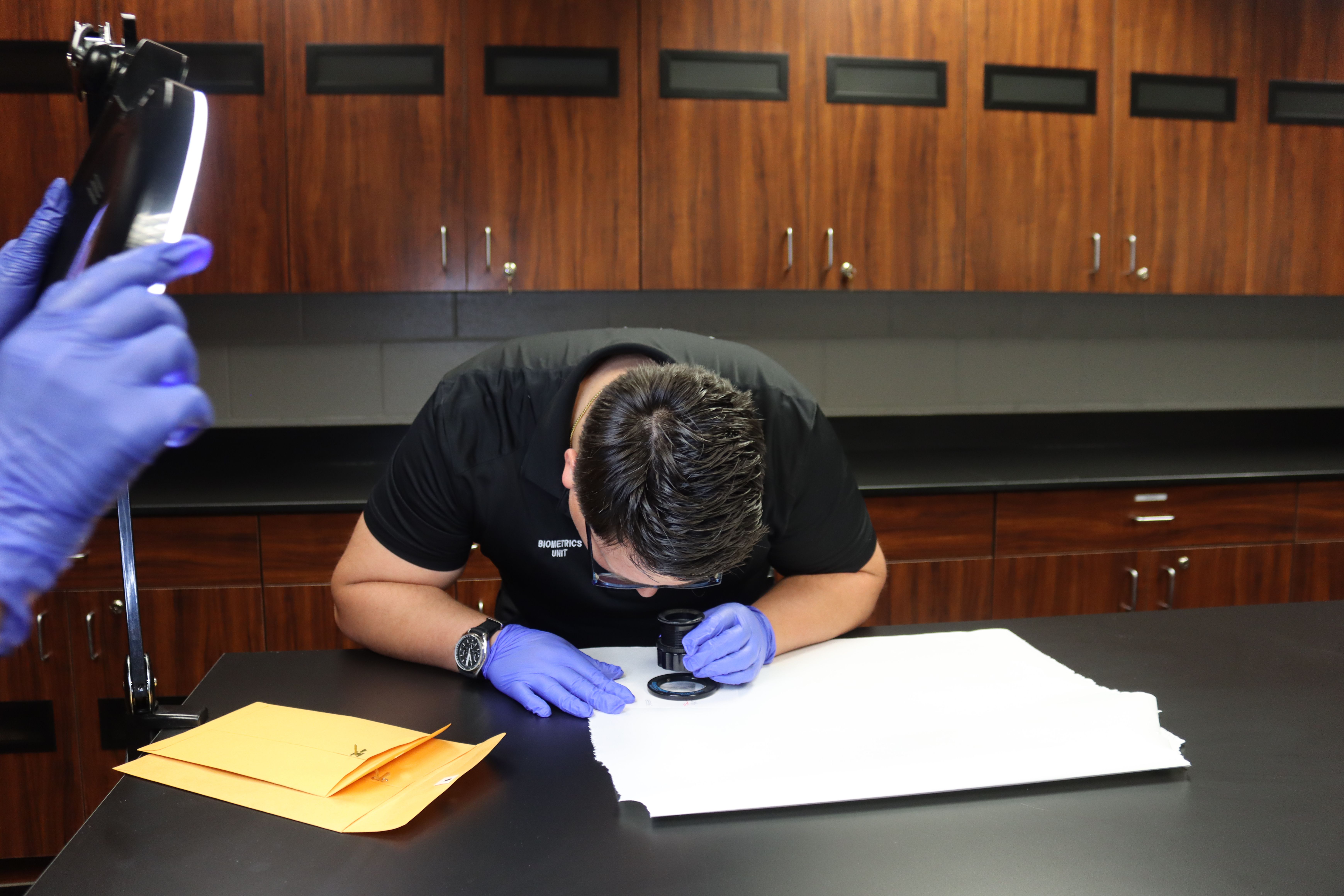Forensic examination workspace with evidence and tools