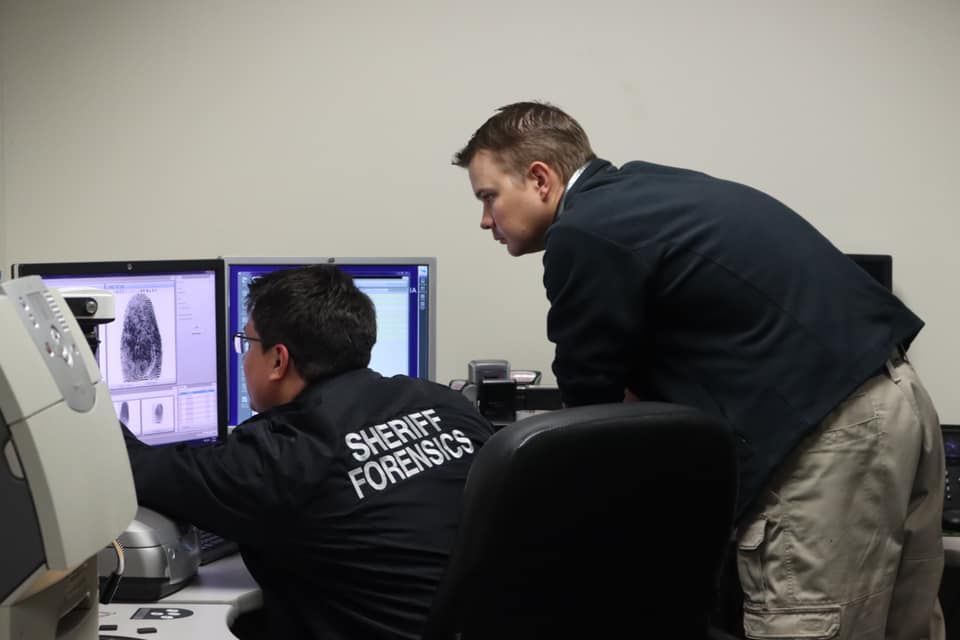 Forensic scientist processing latent fingerprints in the lab