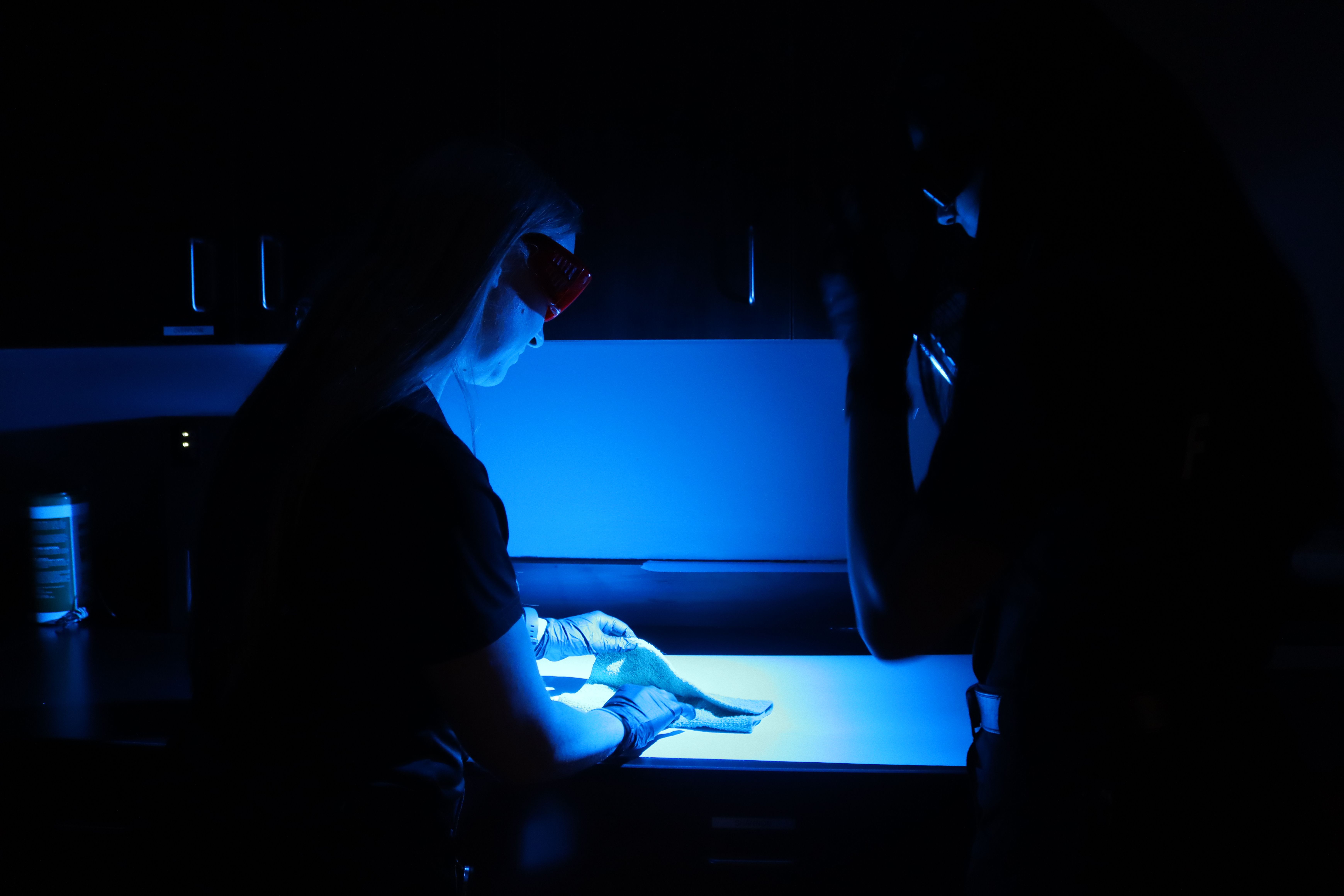 Forensics lab workspace with scientific equipment and evidence